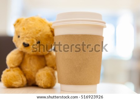 Coffee cup, blurred on teddy bear face in Blurred background with vintage filter