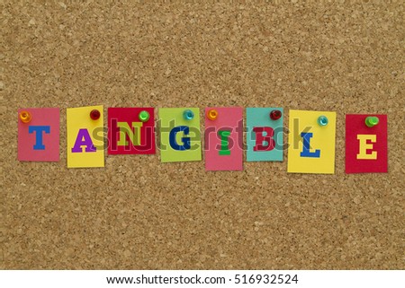 Tangible word written on colorful sticky notes pinned on cork board. Royalty-Free Stock Photo #516932524