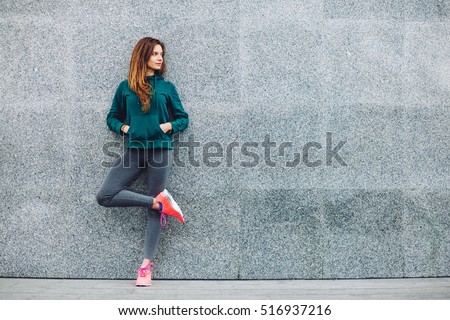 Fitness sport girl in fashion sportswear doing yoga fitness exercise in the street, outdoor sports, urban style Royalty-Free Stock Photo #516937216