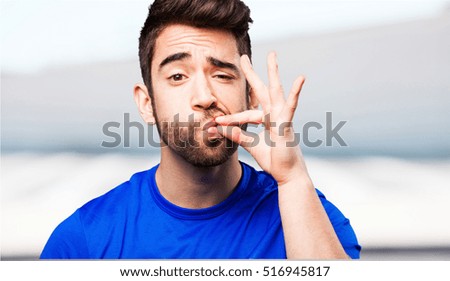 young man doing silence gesture
