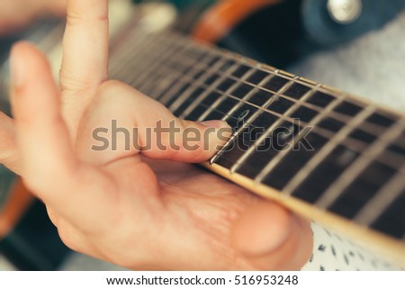 man playing electric guitar 