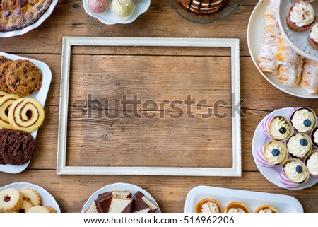 Picture frame and cake, cookies, cakepops, cupcakes. Copy space.