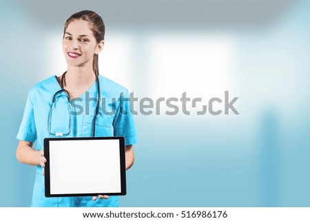 beautiful woman nurse or doctor holding a tablet pc with a blank screen and copy space for advertising