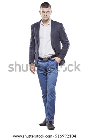 Handsome young man elegantly dressed goes on a white background