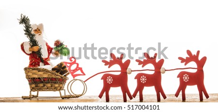 christmas photo of santa claus on sleigh and red wooden deer with christmas tree and gift sack isolated on white background. design for web, poster, card