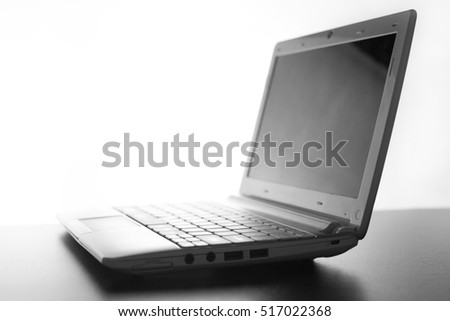 Compact white laptop silhouette on white background