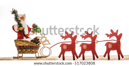 christmas photo of santa claus on sleigh and red wooden deer with christmas tree and gift sack isolated on white background. design for web, poster, card