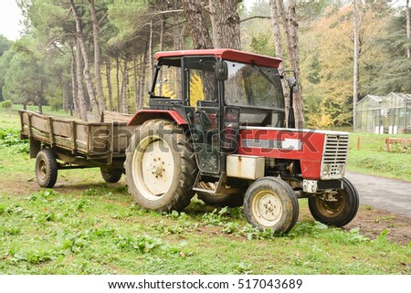 Tractor with trailer in village