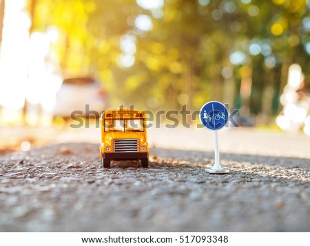 yellow school bus plastic and metal toy model on the country road