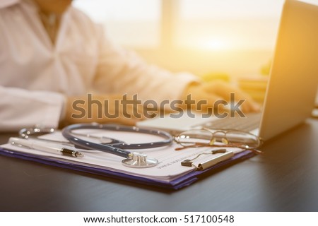 Stethoscope with prescription clipboard and Laptop ,Doctor working an Exam, Healthcare and medical concept,test results in background,vintage color,selective focus Royalty-Free Stock Photo #517100548