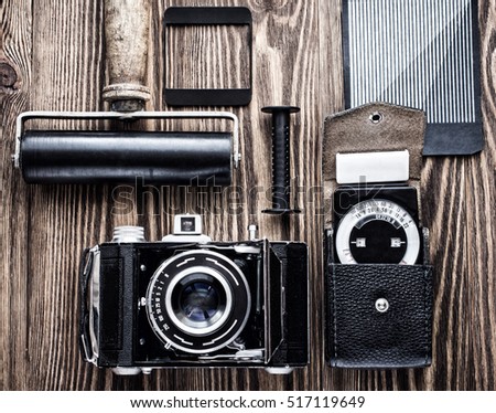vintage camera,exposure meter and another trappings of film photography. photographer's desk