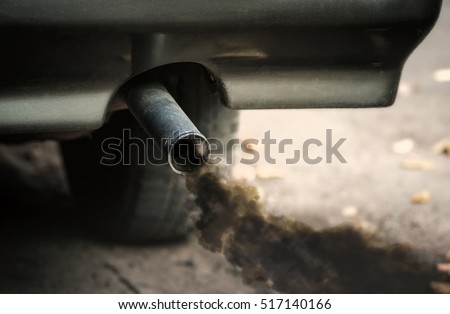 Smoke from old dirty car pipe exhaust. Royalty-Free Stock Photo #517140166