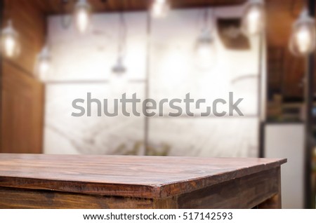 image of wooden table in front of abstract blurred background of resturant lights for display or montage your products.
