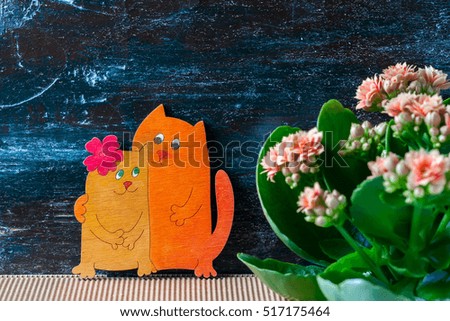 Enamoured cats, Valentine's day. Pink kalanchoe flowers. Selective focus