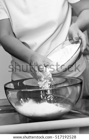 Making dough by female hands on glass table background