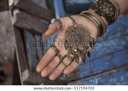 close up of gypsy style woman hands with jewelry