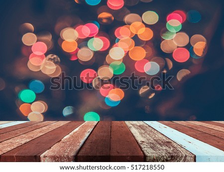 image of wood table and blurred bokeh background with colorful Christmas lights .