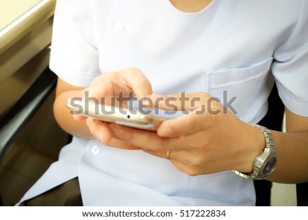 hand holding the white smartphone 