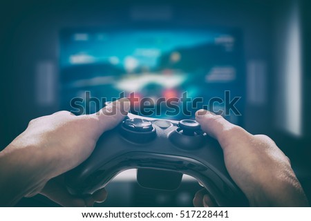 gaming game play tv fun gamer gamepad guy controller video console playing player holding hobby playful enjoyment view concept - stock image Royalty-Free Stock Photo #517228441