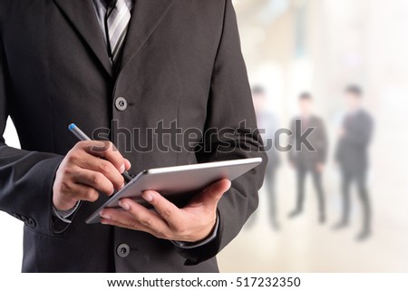 Business man working with a digital tablet Royalty-Free Stock Photo #517232350