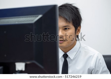 Business men wear white shirts who are using the computer in the office