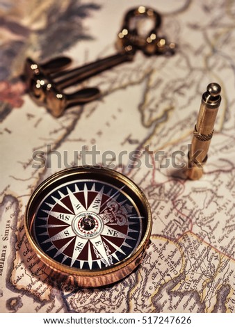 Old compass on vintage map. 