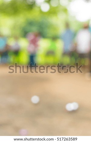 people at sport playing game petanque, blurred