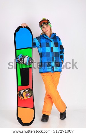 Young attractive woman posing in studio with snowboard on white background