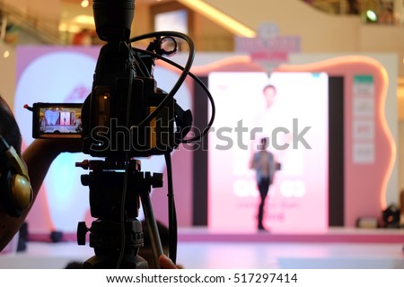 Photographer video recording activity within the event on Stage Royalty-Free Stock Photo #517297414