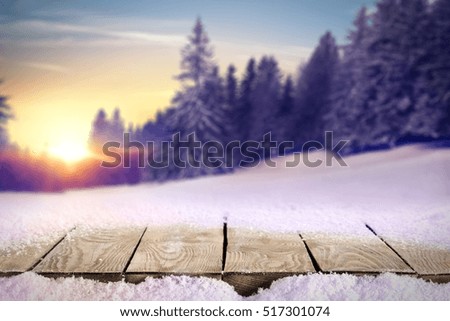 wooden desk place and winter landscape of forest with snow 