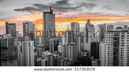 Skyline of Makati City with sunset in the background (city desaturated)