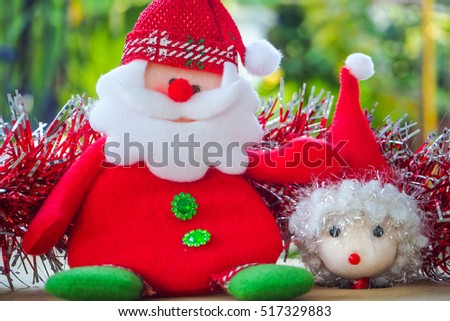 Christmas Concept: Santa Claus and Santa girl Doll