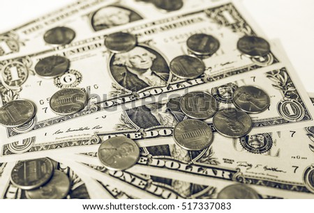 Vintage looking One cent coins and One Dollar banknotes  currency of the United States useful as a background in black and white