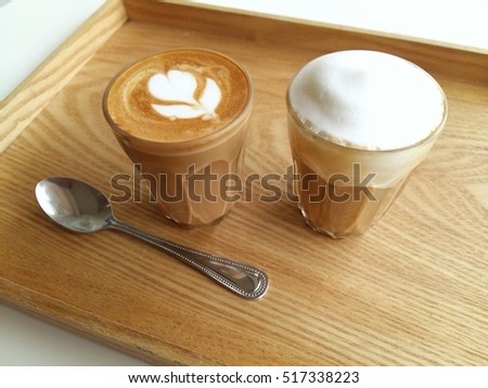 Cappuccino and latte art coffee so dilicious on wood