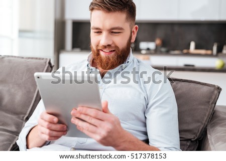 Young man with tablet on sofa. slose up portrait