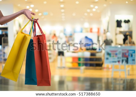 hands holding shoping bags Royalty-Free Stock Photo #517388650