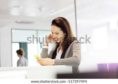 Young businesswoman using mobile phone in office