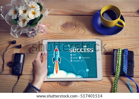 Laptop computer, tablet pc and Success concept on wooden office desk with copy space. Risk design concept background with rocket. 