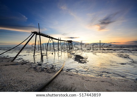 Beautiful sunset at seascape  over the old pier. Soft focus due to long exposure shot. Composition of nature. 