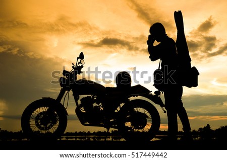 A man riding motorcycle,Silhouettes picture ,play guitar