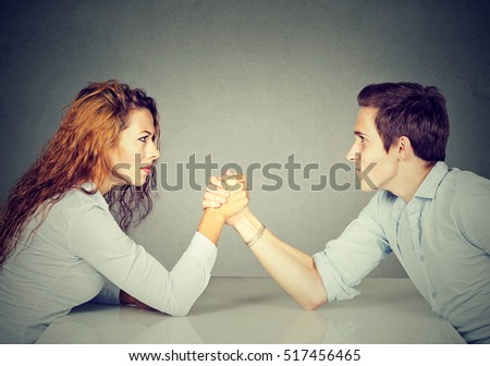 Business people woman and man arm wrestling  