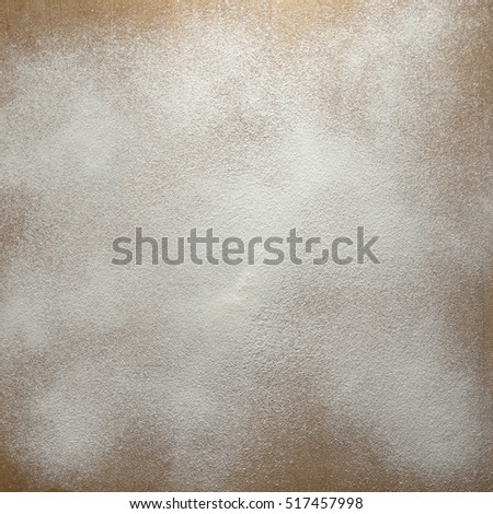 Icing sugar on a wooden board background. 