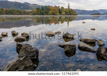 Clear reflections on a calm still Autumn morning at Derwentwater in the Lake District.