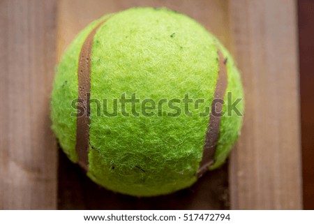 Tennis ball on brown background