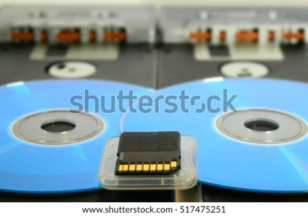 Tapes, floppy disk, cd, memory card. Old and modern technology. Tilt-shift effect applied.