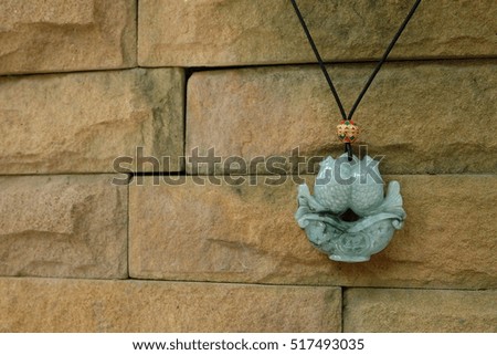 Jade necklace fish with stone walls.