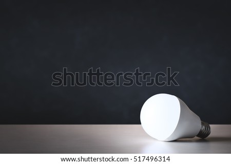 LED light bulb on table with black background Royalty-Free Stock Photo #517496314