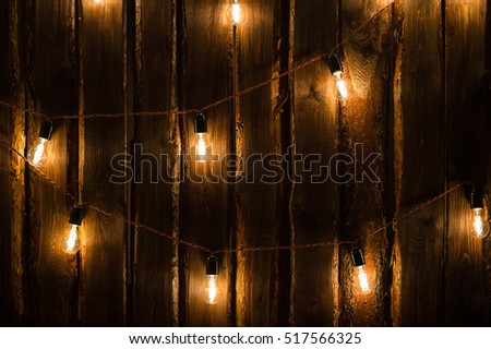Designer light bulbs on dark wooden background