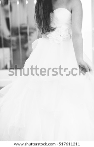 Details of white long bridal dress, wedding day, showroom, abstract, shallow focus, textile, texture, black and white, vertical