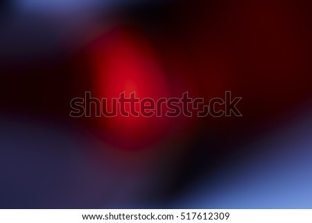 Polygonal red colored light beams in center of solid black background with copy space